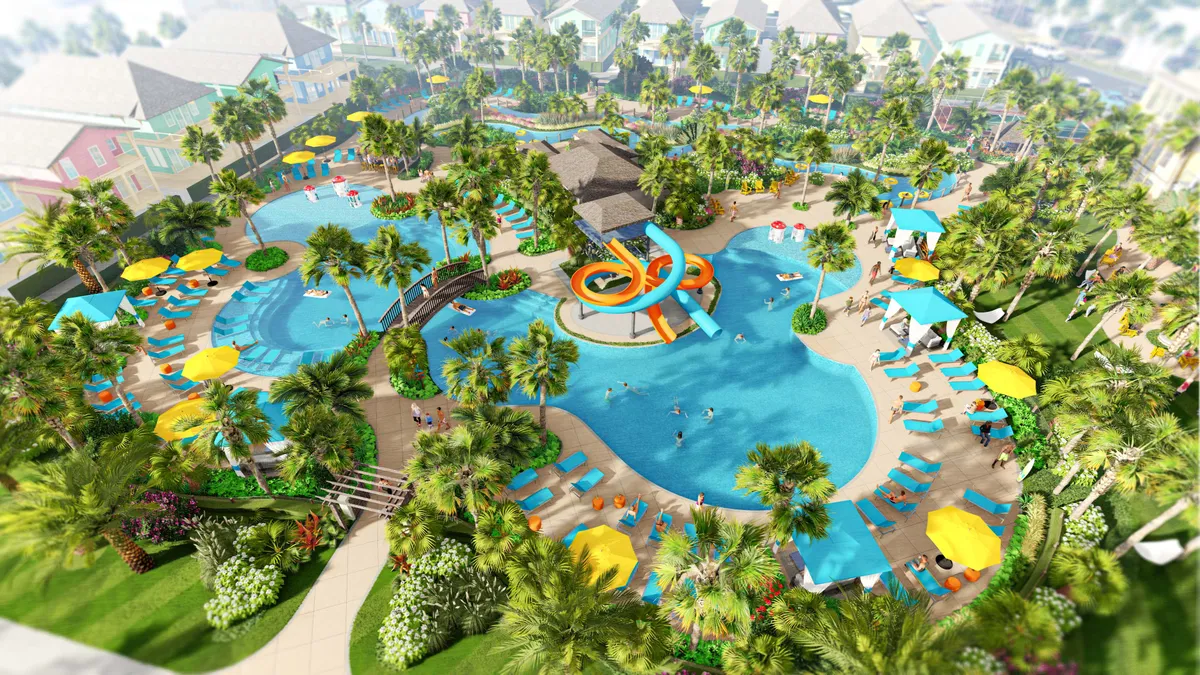 This image features a large resort pool complex with winding waterslides, a lazy river bordered by lush landscaping, colorful poolside umbrellas, and multiple lounge areas. Bridges and pathways connect different parts of the aquatic amenities, and guests are seen enjoying the various water activities.
